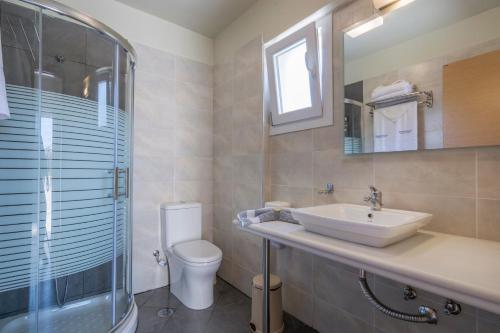 a bathroom with a sink and a toilet and a shower at Sea View Resorts & Spa in Karfas