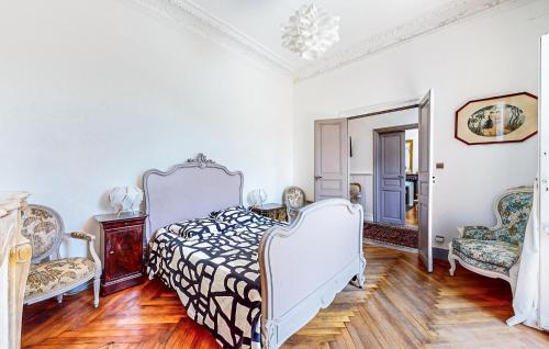 a bedroom with a bed and two chairs at Awesome Home In Capendu in Capendu