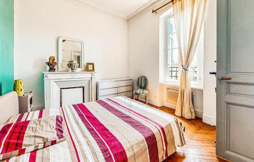 a bedroom with a bed and a fireplace and a mirror at Awesome Home In Capendu in Capendu