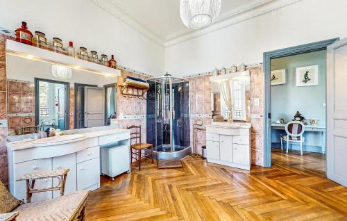 a bathroom with a shower and a wooden floor at Awesome Home In Capendu in Capendu