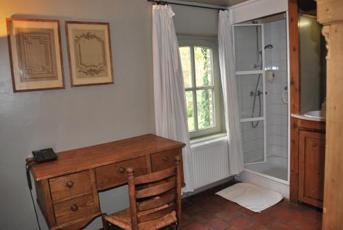 a bathroom with a wooden desk and a shower at Orshof in Oudsbergen 
