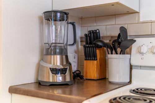 a blender sitting on top of a kitchen counter at Bright & Spacious 2BR & Parking Near TTC & Shops in Toronto