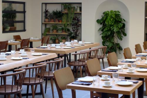 a dining room with wooden tables and chairs at c-hotels Diplomat in Florence