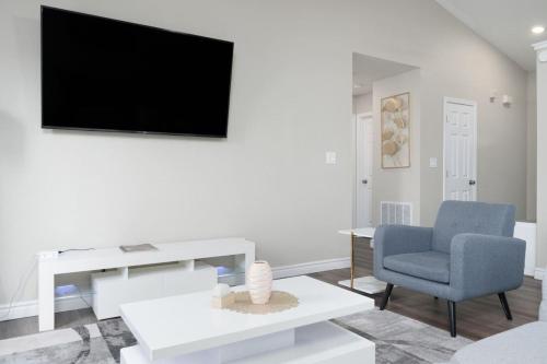 a living room with a tv and a chair and a table at Peaceful Modern Home near Avon in Avon
