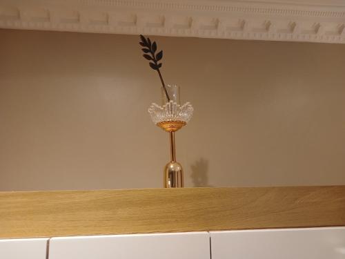 a vase with a flower in it sitting on a counter at Delux Studio apartment in Germiston
