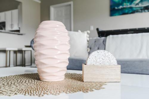a large pink vase and a wooden box on a table at Peaceful Modern Home near Avon in Avon