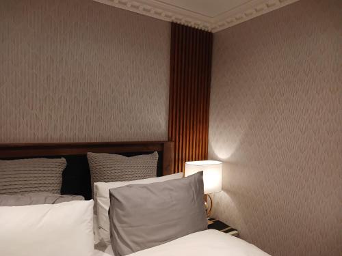 a hotel room with a bed and a lamp at Delux Studio apartment in Germiston