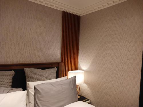 a hotel room with a bed and a lamp at Delux Studio apartment in Germiston