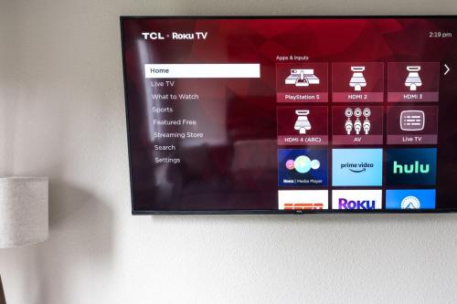 a television screen hanging on a wall withktop at Peaceful Modern Home near Avon in Avon