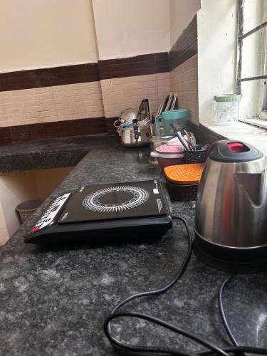 a kitchen counter with a stove top on a counter top at 3 Bhk Air Deck luxury apartment in Patna