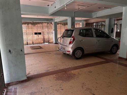 a small car parked in an empty parking lot at 3 Bhk Air Deck luxury apartment in Patna