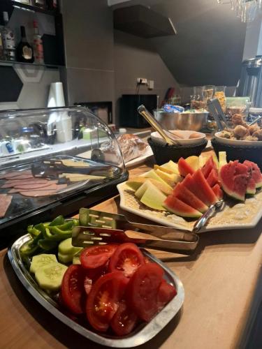 a table topped with plates of food on a counter at Kipos Hotel in Rethymno Town