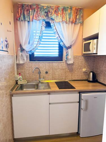a kitchen with a sink and a window at Apartments Bilaja in Marina