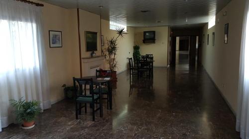a hallway with chairs and a table in a building at Hotel Reina Isabel in Lleida