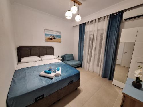 a bedroom with a bed with two trays on it at Sea View Agapi Asprovalta in Asprovalta