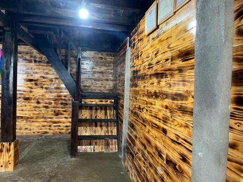 a room with a wall of logs at Sapa Guide Homestay & Trekking in Lao Cai