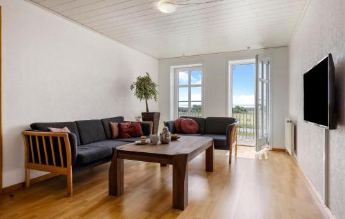 a living room with a couch and a table at 3 Bedroom Gorgeous Apartment In Højer in Højer