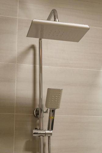 a shower head and a light in a bathroom at Hanhhome in Ho Chi Minh City