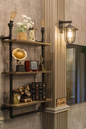 a room with three shelves on a wall at Hanhhome in Ho Chi Minh City