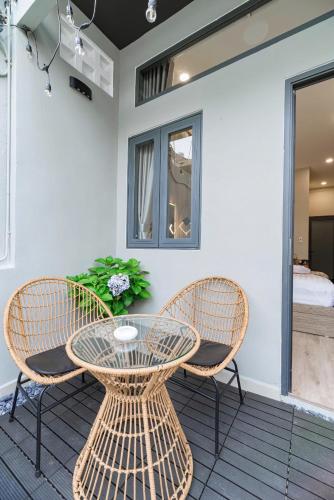 a table and two chairs on a patio at Hanhhome in Ho Chi Minh City
