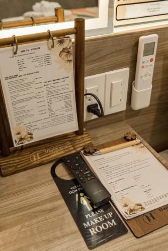 a remote control sitting on top of a desk at Hanhhome in Ho Chi Minh City