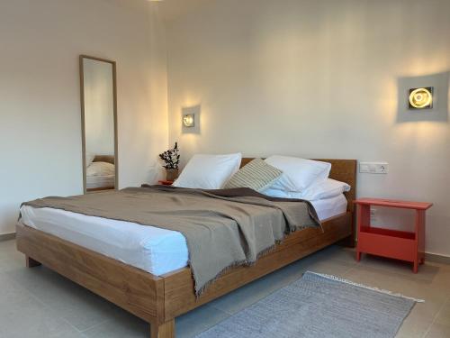 a bedroom with a large bed and a mirror at Lukenda Rooms - Boutique Apartments with view of Adriatic Sea in Pakoštane