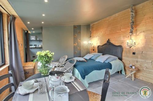 a bedroom with a bed and a table with chairs at Chez patricia in Ploubazlanec