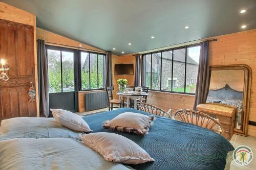 a bedroom with a large bed with pillows on it at Chez patricia in Ploubazlanec