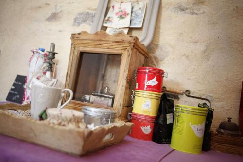 a table with three buckets and a mirror on it at Chez patricia in Ploubazlanec