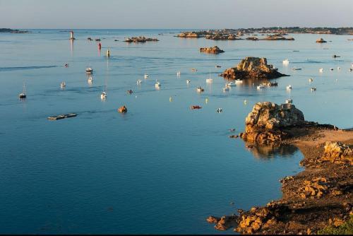 a large body of water with boats in it at Chez patricia in Ploubazlanec