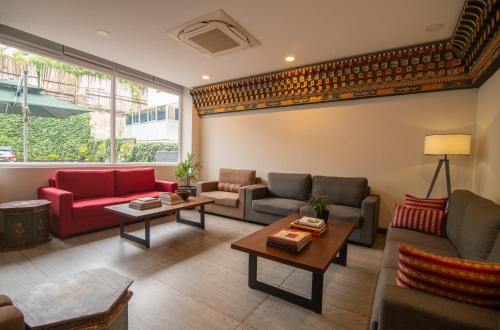 a living room with couches and chairs and a table at Bhutan Peaceful Residency and Spa in Thimphu