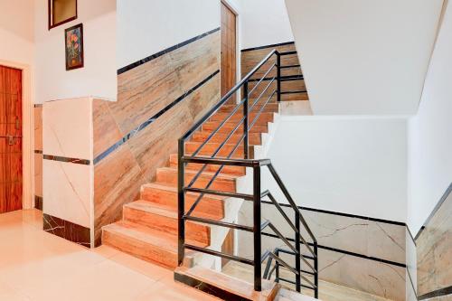 a staircase in a home with wooden stair treads at Hotel O Bluestar in Bengaluru