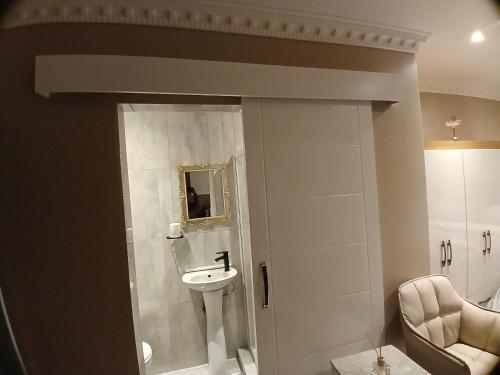 a bathroom with a sink and a toilet and a mirror at Delux Studio apartment in Germiston