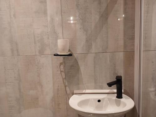 a bathroom with a toilet and a sink with a cup at Delux Studio apartment in Germiston