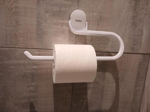 a roll of toilet paper hanging on a wall at Delux Studio apartment in Germiston