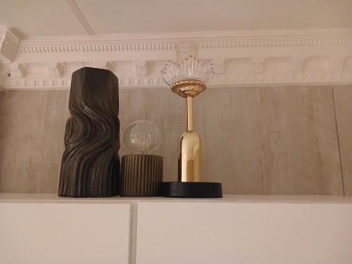 a lamp sitting on top of a white shelf at Delux Studio apartment in Germiston