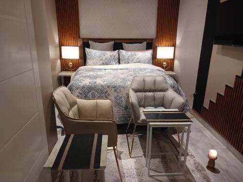 a bedroom with a bed and a table and chairs at Delux Studio apartment in Germiston
