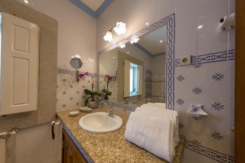 a bathroom with a sink and a mirror at Casa de São Domingos in Peso da Régua