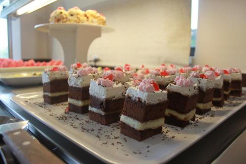 a bunch of cakes on a tray on a counter at Vallian Village Hotel in Paradeísion