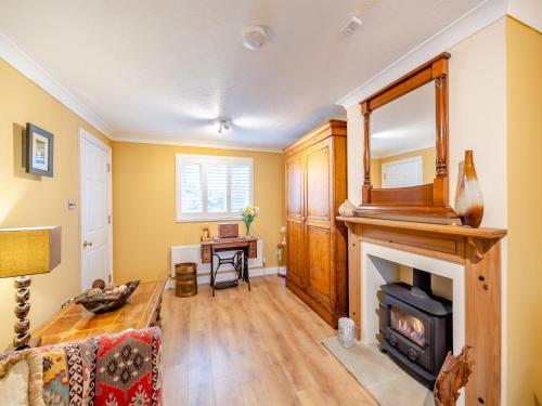 a living room with a fireplace and a table at The Roddy House in West Bay