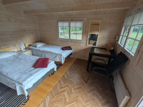 Postel nebo postele na pokoji v ubytování Ruhnu Timu talu puhkemajad