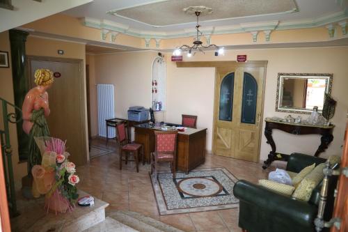 a living room with a woman standing in a room at Villa Manno in Barcellona-Pozzo di Gotto