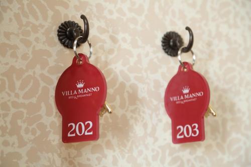 a pair of red earrings with the words willias manana at Villa Manno in Barcellona-Pozzo di Gotto