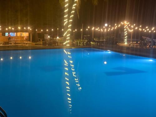 a large swimming pool with lights around it at Hotel Coral Bay in Trincomalee
