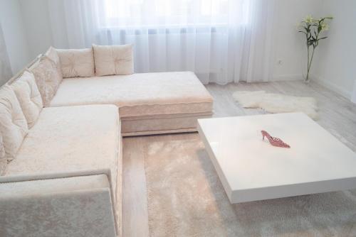 a living room with a couch and a butterfly on a table at Sofia Apartment in Budapest