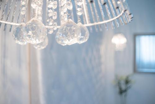 a chandelier with crystals hanging from the ceiling at Sofia Apartment in Budapest