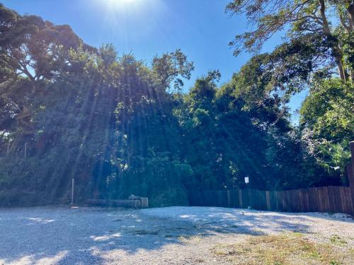 a large yard with a fence and trees at Star Forest Camp Hayama in Hayama