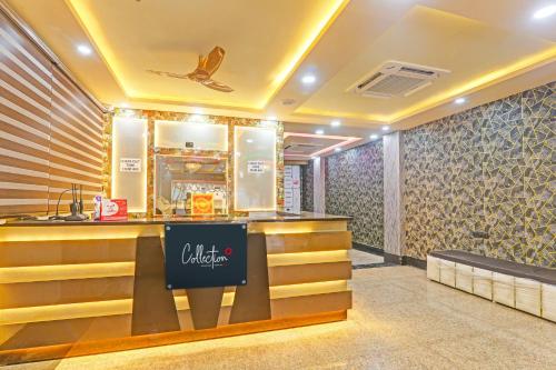 a restaurant with a counter in a room at Collection O Sheesh Mahal Hotel in Patna