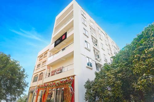 a white building with christmas decorations on it at Collection O Sheesh Mahal Hotel in Patna