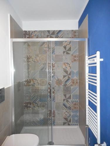 a shower with a glass door in a bathroom at Anaka sweet home in Agrigento